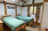 Cuckoo's Nest Tree House twin bedroom at Florence Springs Glamping Village - luxury glamping near Tenby, Pembrokeshire, South West Wales